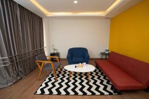 a living room with a couch and a table at Nite & Day Laguna Bintan in Tanjung Pinang