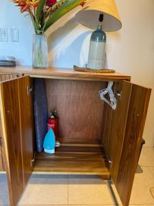 a cabinet with a vase on top of it at Ruca Lodge - Luxury Container Tiny Home Surrounded by Nature in Uvita
