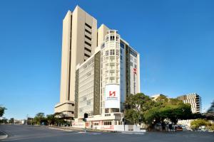 a large building with a sign on the side of it at Swiss-Belhotel Woolloongabba, Brisbane in Brisbane