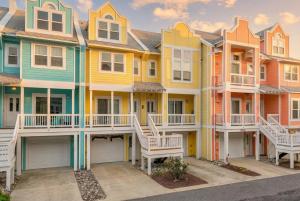 a row of colorful houses in a row at The Wright Stuff OBX in Kill Devil Hills