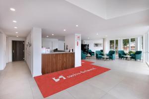 an office with a red rug in the middle of a lobby at Swiss-Belhotel Woolloongabba, Brisbane in Brisbane +28 photos