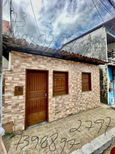 a house with two doors and graffiti on the ground at Casa em Itacaré no Centro, ao lado da Pituba in Itacaré