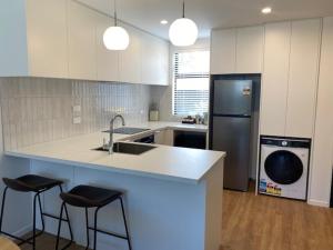 a kitchen with a sink and a dishwasher at Colombo Executive Apartments in Christchurch