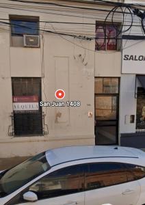 a white car parked in front of a building at Alojamiento Victoria in Corrientes