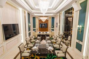 a dining room with a long table and chairs at THE PREMIER PALACE HOTEL AND SPA in Phnom Penh