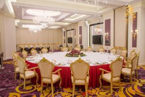 a large meeting room with a large table and chairs at THE PREMIER PALACE HOTEL AND SPA in Phnom Penh