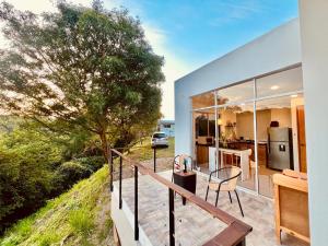 a balcony of a house with a table and a tree at Finca Samana in Tocaima
