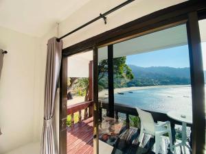 a room with a balcony with a view of the ocean at Paradise view A7-Kantiang paradise resort- in Ko Bu Bu