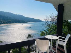 a balcony with a table and chairs and a view of the water at Paradise view A7-Kantiang paradise resort- in Ko Bu Bu +2 photos