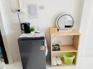 a small refrigerator in a room with a mirror at Paradise view A7-Kantiang paradise resort- in Ko Bu Bu