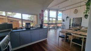 a kitchen and dining room with a table and chairs at Waterview Gosford Motor Inn in Gosford