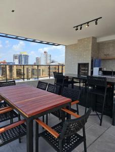 a dining room with tables and chairs on a roof at Flat Azzure 205 in Cabedelo