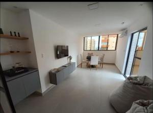 a white room with a kitchen and a living room at Flat Azzure 205 in Cabedelo +4 photos