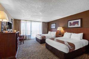a hotel room with two beds and a television at Scenic View Inn - Lake Powell - Page AZ in Page +37 photos