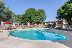a swimming pool at a resort with tables and chairs at Scenic View Inn - Lake Powell - Page AZ in Page
