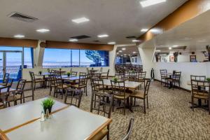 a dining room with tables and chairs and windows at Scenic View Inn - Lake Powell - Page AZ in Page