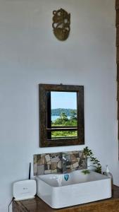 a bathroom with a white sink and a mirror at The Bay Lookout in Kaôh Rŭng (3)