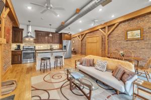 a living room with a couch and a kitchen at Moore on Main in Abingdon