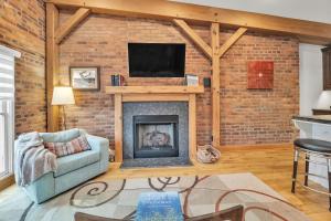 a living room with a brick wall and a fireplace at Moore on Main in Abingdon