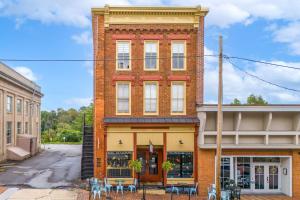 a brick building with tables and chairs in front of it at Moore on Main in Abingdon