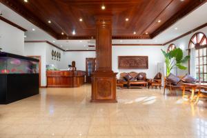 a lobby with couches and a tv in a room at Domi Hotel in Siem Reap