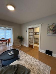 a living room with a couch and a table at A home in Niagara falls- The Maple and Mist in Niagara Falls