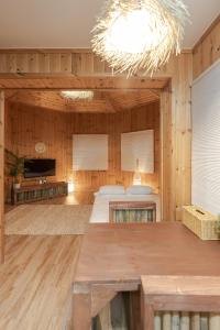 a large room with two beds and a chandelier at 감성제주스테이 in Songnang-dong