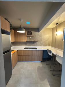 a kitchen with wooden cabinets and a white counter top at Villa Bamboo in San Juan