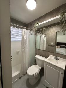 a bathroom with a toilet and a sink and a shower at Villa Bamboo in San Juan +33 photos