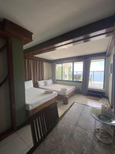 a large room with a bed and a window at My Honey's Farm in Nangkaan +36 photos