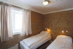 a room with a bed and a window in it at Modern Comforts, and Ski Access in Beitostøl +21 photos