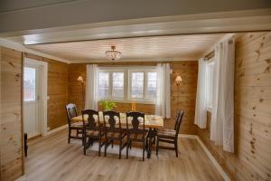 a dining room with a table and chairs at Modern Comforts, and Ski Access in Beitostøl