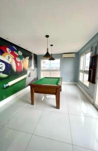 a gaming room with a pool table and a mural at Apto 204 in Barcarena
