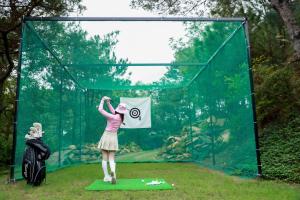 a woman standing on a green mat holding a sign at Amaya Retreat in Sóc Sơn