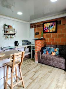a living room with a couch and a table at Apartaestudio Queremal in Papagalleros