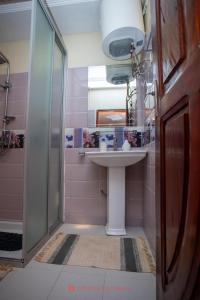 a bathroom with a sink and a shower at Cabral residence in Guediawaye