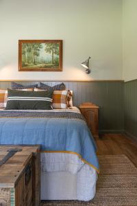 a bedroom with a bed with a dog sitting on it at Mara Luxe Farm Stay 20 mins from Beach in Forster +24 photos