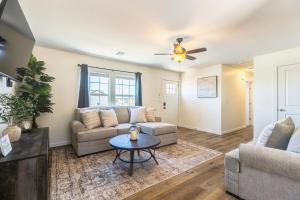 a living room with a couch and a table at Stylish New Construction Home in Salina