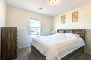 a bedroom with a large bed and a window at Stylish New Construction Home in Salina