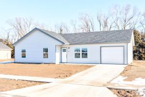 a white house with a garage at Stylish New Construction Home in Salina
