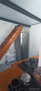 a kitchen with a stove and a stainless steel refrigerator at Casa Belíssima in Pelotas +12 photos