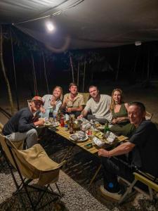 a group of people sitting around a table in a tent at Ko Kut Nature Camp in Ko Kood