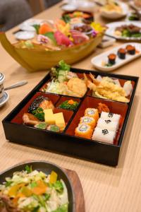 a table with a tray of different types of sushi at THE PREMIER PALACE HOTEL AND SPA in Phnom Penh