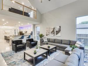 a living room with a couch and tables and a kitchen at Captivating 6BR 3B Home with Pool & Fire Pit in Mesquite
