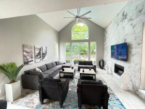 a living room with a couch and a stone wall at Captivating 6BR 3B Home with Pool & Fire Pit in Mesquite