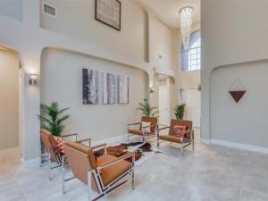 a living room with chairs and a wall at Captivating 6BR 3B Home with Pool & Fire Pit in Mesquite
