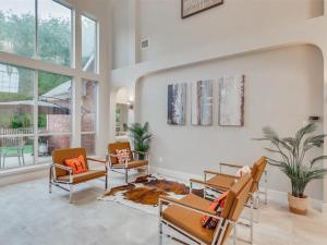 a living room with two chairs and a table at Captivating 6BR 3B Home with Pool & Fire Pit in Mesquite