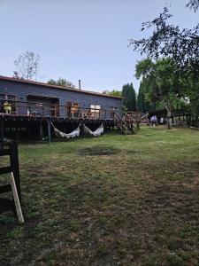 a building with hammocks in front of a yard at Casa en Panguipulli in Neltume +13 photos