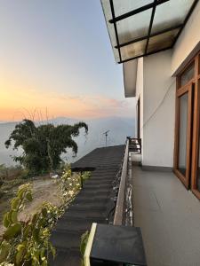 a balcony of a house with a view of the ocean at Bagaan Villa Homestay in Ilām