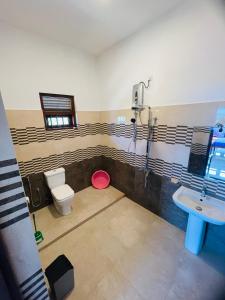 a bathroom with a toilet and a sink at Hotel Meer in Ambalangoda +83 photos